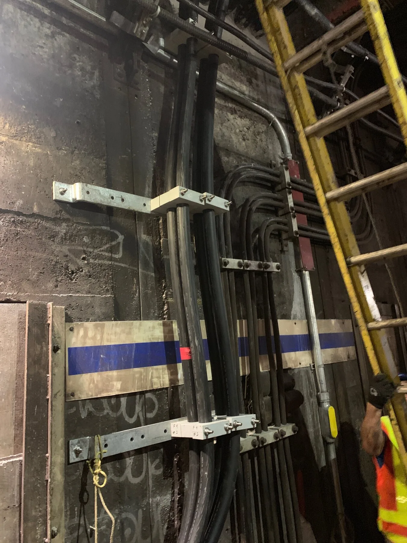 New conduits and cabling installed along a tunnel wall