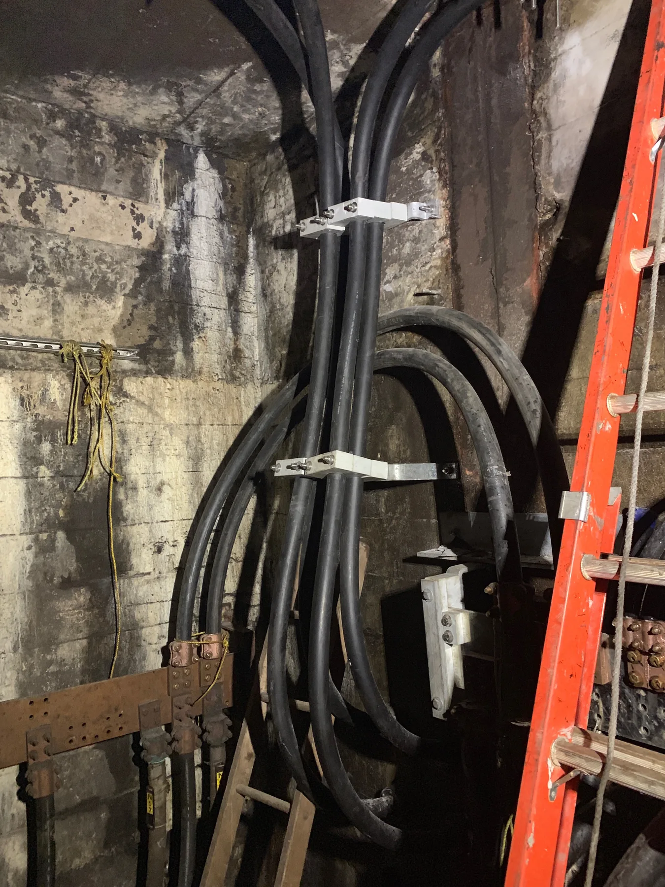 Organized conduit bends installed on an underground wall