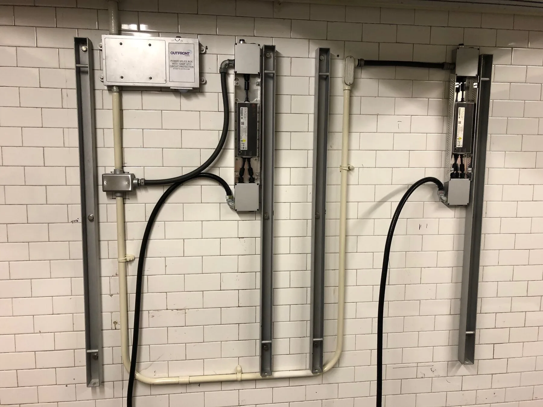 Precision conduit installation on a tiled station wall
